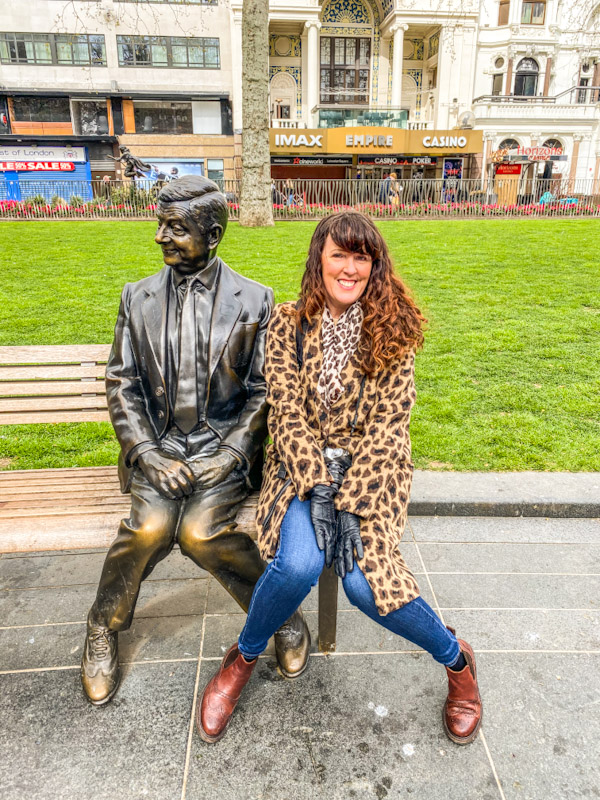 Mr Bean Statue in Leicester Square Perfect for a selfie. Woman sitting next to Mr bean