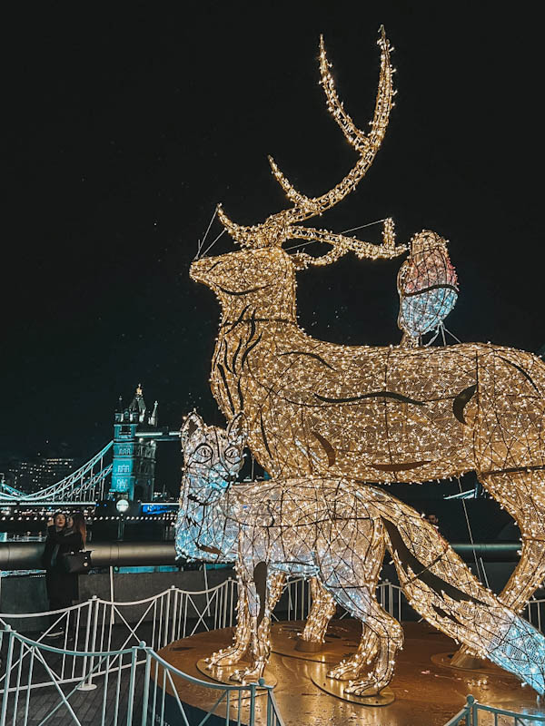 Stunning Christmas decorations and views on  Christmas by the River market. View of giant reindeer and Tower bridge