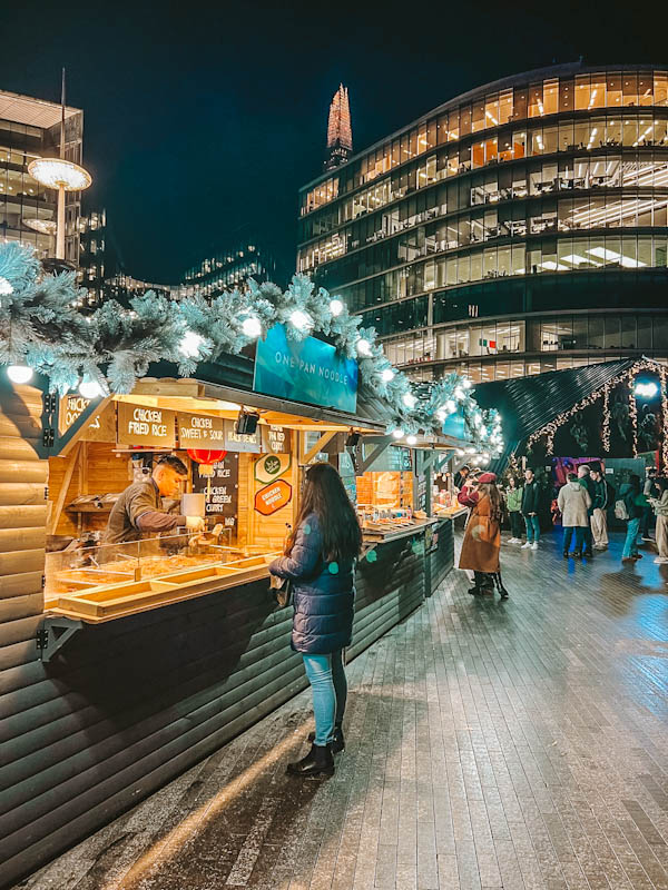Christmas By the river Stalls London market with the shard behind it