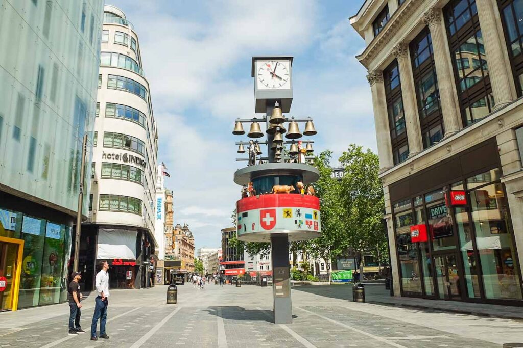 The Swiss Glockenspiel Clock in London's piccadilly Circus with view of the square behind